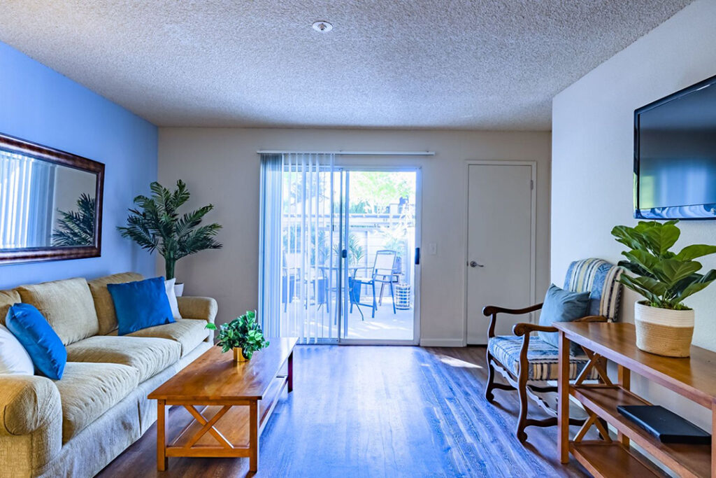 Interior living room with sliding glass doors of Country Brook apartment